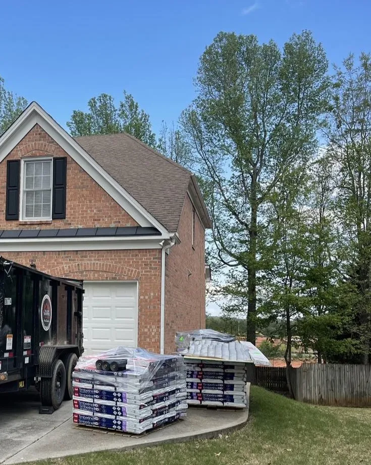 Pallets of GAF Timberline shingles staged at a Hill Top job site